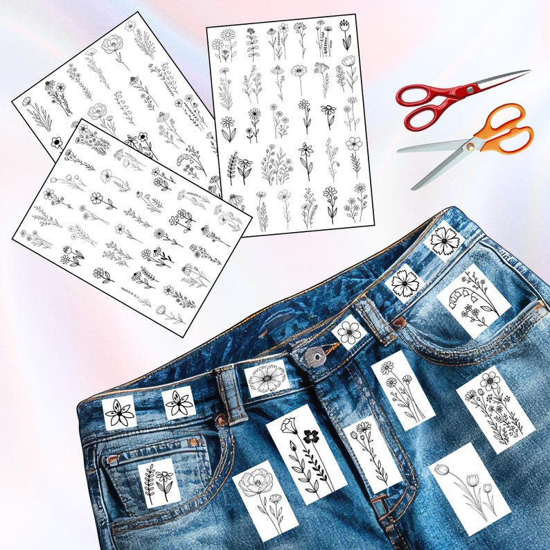 May include: Three sheets of black and white floral stickers with various flower designs. A pair of red and orange scissors are next to a pair of blue jeans with floral stickers on the pockets. The stickers are for DIY crafts.