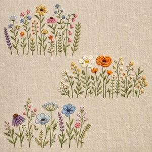May include: Embroidered floral design featuring colorful wildflowers in shades of yellow, pink, blue, and orange. The flowers are stitched on a beige fabric, creating a textured and artistic look. The design includes various flower types and green stems.