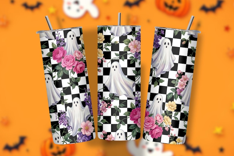 May include: Three cylindrical tumblers with metal straws, featuring a black and white checkered pattern overlaid with white ghost illustrations and clusters of pink, purple, and yellow flowers with green leaves on a white background.
