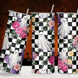 May include: Three cylindrical tumblers with metal straws featuring a black and white checkered pattern overlaid with illustrations of white ghosts, pink roses, purple flowers, and green leaves. The design wraps around the entire surface of each cup.