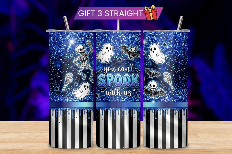 May include: Three cylindrical tumblers with straws featuring a blue glitter background, white ghosts, skeletons, and bats. The center tumbler displays the text "you can't SPOOK with us" in blue and white. The bottom section has a blue drip effect over black and white vertical stripes.