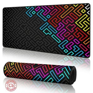 May include: A black rectangular mouse pad with a colorful geometric design. The design features a maze-like pattern in shades of blue, pink, orange, and yellow. The mouse pad is shown rolled up and flat.