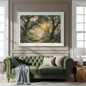 May include: A framed landscape print depicting a sunlit forest with mossy trees, ferns, and a winding path, displayed above a tufted olive green sofa with a grey throw blanket, two beige pillows, and a white lamp on a gold geometric side table.