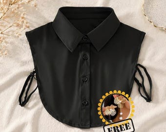 May include: A black detachable shirt collar with a button-down front and tie closures. The collar has a classic pointed collar design. A small graphic with the word "FREE" is in the lower right corner.