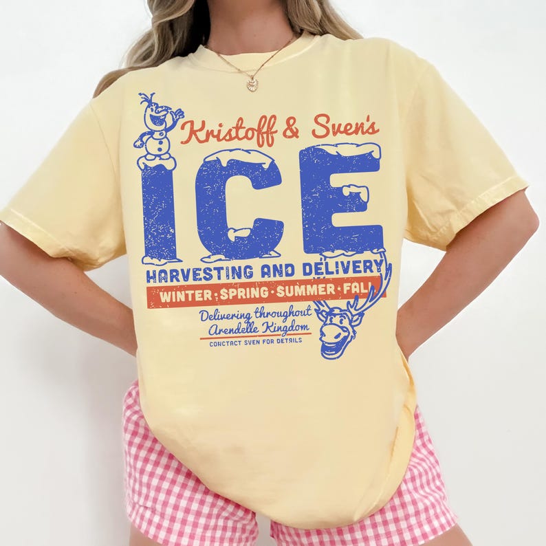 May include: A light yellow t-shirt featuring the text "Kristoff & Sven's ICE" in blue and red, with a distressed vintage look. The shirt also includes graphics of Olaf and Sven, and the text "Harvesting and Delivery".