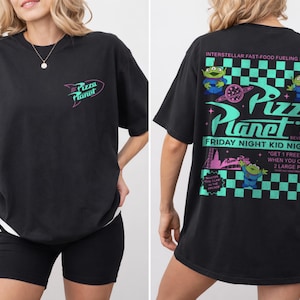 May include: Black t-shirt with the Pizza Planet logo on the front and a graphic on the back. The back graphic features the text "Pizza Planet" with alien characters, a planet, and the words "Friday Night Kid Night."