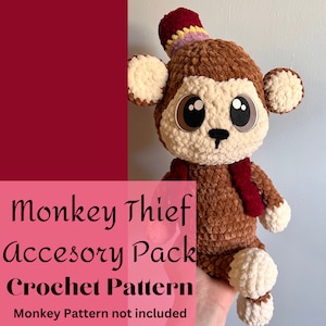 May include: A handmade crochet monkey with a red scarf and a small hat. The monkey has large, expressive eyes and is made of brown and cream-colored yarn. The image includes text that reads "Monkey Thief Accessory Pack Crochet Pattern."