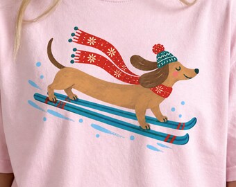 Perro salchicha esquiando PNG / Imágenes prediseñadas de perros navideños / Gráfico de vacaciones de invierno / Diseño de camiseta festiva con perro salchicha