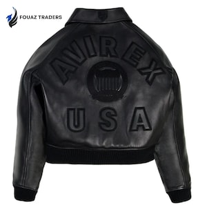 May include: Black leather jacket with the text "AVIREX USA" on the back. The jacket has a ribbed hem and cuffs, a collar, and a logo on the upper back. The jacket is a bomber style.