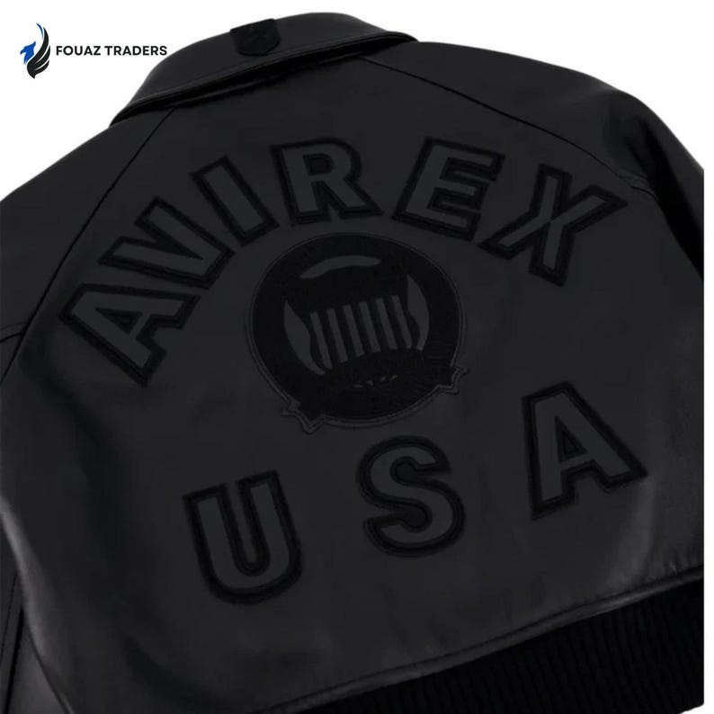 May include: Black leather jacket with the word "AVIREX" arched across the back, along with a circular emblem and the letters "USA". The jacket has a ribbed hem and a buttoned collar. The brand name "FOUAZ TRADERS" is in the top left corner.