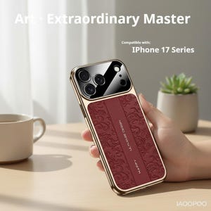 May include: A gold-colored iPhone 17 series phone case with a burgundy leather-like panel featuring an embossed floral design. The case has a shiny black camera lens cover and the text "Art Extraordinary Master".