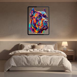 A framed colorful pop art dog portrait hanging above a neatly made bed with neutral bedding.