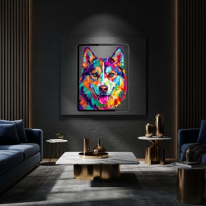 A framed colorful pop art dog portrait displayed on a dark wall in a dimly lit contemporary interior.