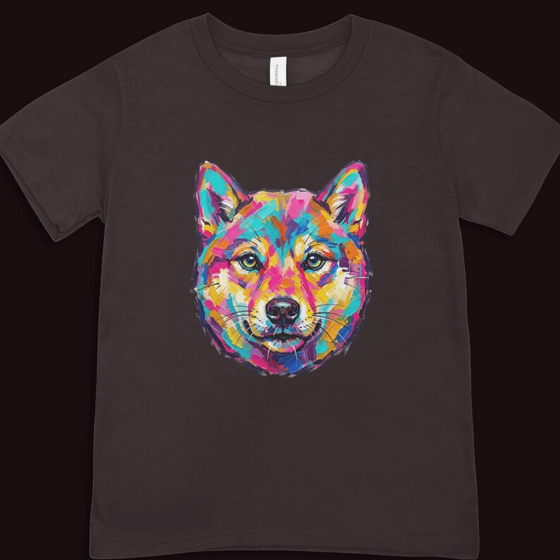 A dark brown short-sleeved t-shirt displaying a colorful pop art portrait of a Shiba Inu style dog.