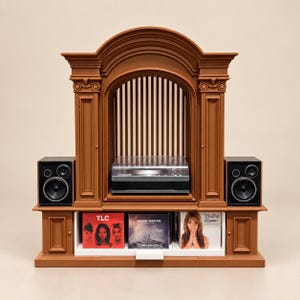May include: A brown, arched, architectural-style display stand featuring a central turntable with a clear cover, flanked by two black speakers. The lower section includes a white shelf holding three music albums by TLC, Imagine Dragons, and Britney Spears.