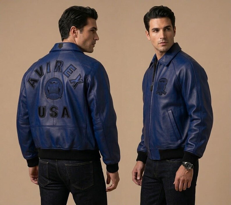 May include: A blue leather jacket with a black collar and cuffs. The back of the jacket features the text "AVIREX USA" in black. The jacket has a zipper closure and a small patch on the chest.