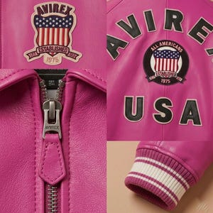May include: Close-up of a bright pink leather jacket with multiple patches. The jacket features a zipper with the brand name "AVIREX" and a ribbed cuff with white stripes. Patches include the American flag and the text "ESTABLISHED 1975".
