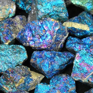 May include: A collection of iridescent blue, green, and purple chalcopyrite crystals. The crystals have a rough, natural texture and are a popular choice for collectors and metaphysical enthusiasts.