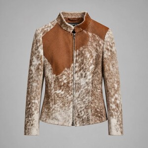 May include: A cowhide jacket in shades of brown and white, featuring a stand-up collar and a full-length zip. The jacket has a solid brown panel on the upper chest and shoulders. It has long sleeves and a fitted design.