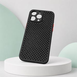 May include: A black smartphone case featuring a uniform grid of circular perforations across the back surface. The case includes a raised rectangular cutout for a triple-lens camera system and distinct red buttons on the side edges.