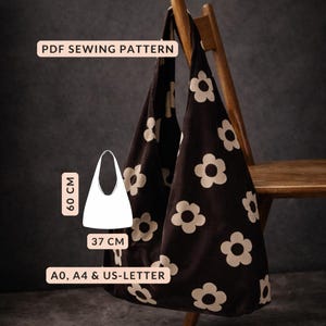 May include: A black tote bag with a white floral pattern, 60 cm high and 37 cm wide. The bag is hanging on a wooden chair. The text "PDF SEWING PATTERN" is at the top. The pattern is available in A0, A4 & US-LETTER sizes.