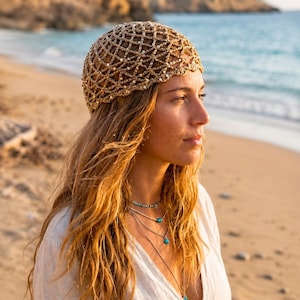 May include: A tan crochet skull cap featuring an open net pattern embellished with small, reflective silver sequins throughout the weave. The headwear is constructed from a textured, natural-toned fiber and fits snugly over the crown of the head.
