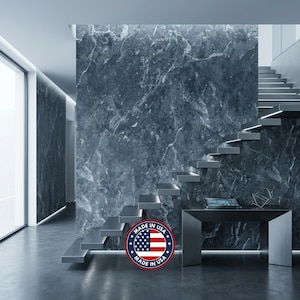 May include: A dark gray marble wall covering with white veining patterns, featuring a floating staircase and a console table. A circular badge with the text Made in USA and a graphic of the American flag is overlaid on the lower center area.