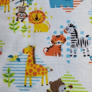 May include: White fabric with a repeating pattern of colorful animals, including a giraffe, zebra, lion, tiger, monkey, bear, and fox. The animals are surrounded by green leaves and blue and white stripes.