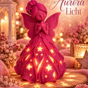 May include: A magenta fairy figurine with a floral-adorned hairstyle, holding a star, and wearing a dress with star-shaped cutouts that emit a warm internal glow. The text Aurora Licht is visible in the upper right corner of the image.