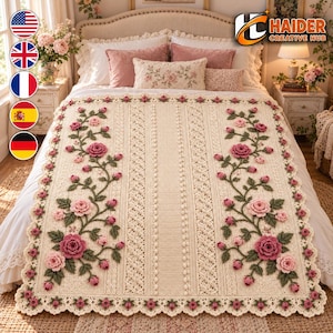 May include: A cream-colored crochet blanket featuring intricate vertical textured panels and two prominent floral vine patterns. The design includes three-dimensional pink and dark rose-colored roses, buds, and green leaves, finished with a scalloped edge.