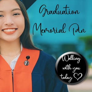 May include: A graduation memorial pin with a photo and the words "Walking with you today" on a black button. The pin is worn on a graduation gown with an orange and blue color scheme. The text "Graduation Memorial Pin" is also visible.