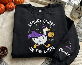 ハロウィンのガチョウ刺繍スウェットシャツ、不気味なガチョウが逃げ出したクルーネック、魔女のガチョウのパンプキンシャツ、パーソナライズされた袖のセーター