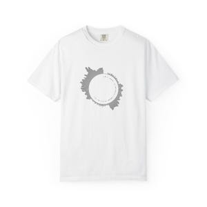 以下が含まれることがあります： 中央にグレーのグラフィックが施された白い半袖Tシャツ。デザインは、無地の白い中心部を囲む円形の音波パターンで構成されており、グレーの波形の内部エッジに沿って小さなテキストが印刷されています。
