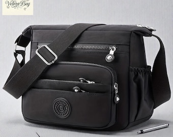 Bolso bandolera ligero de nailon: bolso de viaje multibolsillos y resistente al agua.