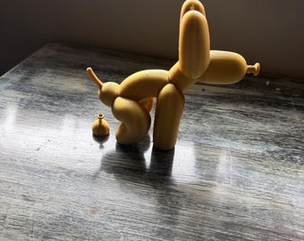 Balloon dog with a balloon poop