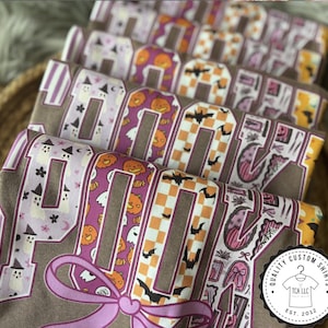 Spooky Season Pattern Letter Shirt | Cute Halloween Coquette Bow Tee | Trendy Pink Fall Graphic Shirt | Women's Autumn Pumpkin Tee