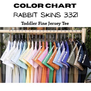 May include: A color chart for Rabbit Skins 3321 toddler fine jersey tees. The chart displays a variety of colors, including white, ash, silver, light blue, saltwater, butter, peachy, pink, orange, mauve, raspberry, vintage green, and more.