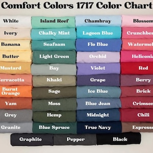 May include: A color chart displaying a variety of Comfort Colors 1717 fabric swatches. The chart features a wide range of colors, including white, ivory, banana, butter, mustard, terracotta, burnt orange, yam, grey, granite, island reef, chalky mint, seafoam, light green, bay, khaki, sage, moss, hemp, blue spruce, chambray, lagoon blue, flo blue, orchid, violet, grape, ice blue, blue jean, midnight, true navy, blossom, crunchberry, watermelon, heliconia, red, berry, brick, crimson, chili, espresso, graphite, pepper, and black.
