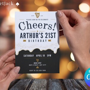 May include: A birthday invitation card with the text "Cheers! Arthur's 21st Birthday". The card has a black and white design with a beer foam effect. The date and time are included. The card is held by two hands.