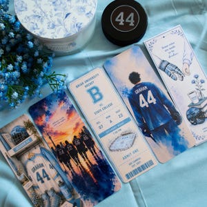 May include: A collection of four rectangular paper bookmarks featuring hockey-themed illustrations, a black hockey puck with the number 44, and a round candle container with a blue and white floral pattern. The bookmarks display hockey players, jerseys, and game ticket graphics.