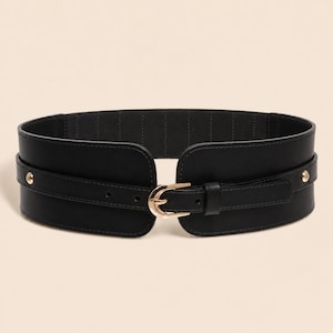 May include: A wide black elasticized waist belt featuring a smooth front panel with a gold-toned metal buckle and matching gold-toned studs on each side. The belt has a structured design with a central strap that secures through the buckle.