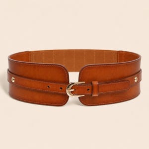 May include: A wide brown leather belt featuring a smooth finish, a gold-toned metal buckle, and two gold-toned metal studs on the sides. The belt has a structured design with a secondary narrow strap overlay that secures with the central buckle.