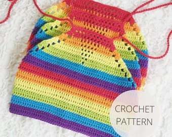May include: A rainbow crochet top with a crocheted halter neckline. The top is made with a variety of colours, including red, orange, yellow, green, blue, and purple. The top is laid flat on a white surface. CROCHET PATTERN is written in white text on a white circle.