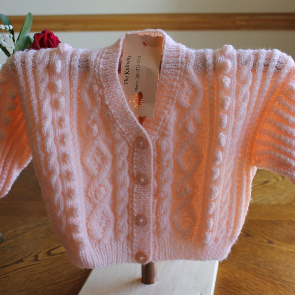 A Delicate Peach Colored Aran Style Cardigan:  12 to 18 months