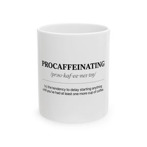 May include: White ceramic coffee mug with the word "PROCAFFEINATING" printed in black, along with its phonetic pronunciation and definition. The mug is cylindrical and has a simple, clean design.