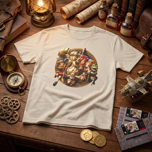 May include: A cream-colored short-sleeve t-shirt featuring a circular graphic print of a group of fantasy characters, including a robot, a frog, and several human figures, all rendered in a detailed, colorful, and animated art style.