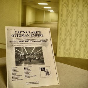 May include: A printed advertisement for Cap'n Clark's Ottoman Empire featuring the text "It's all here and it's all a steal!" and a list of furniture items including couches, chairs, stools, tables, desks, media consoles, nightstands, dressers, beds, and more.