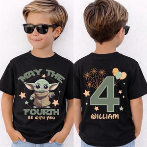May include: Black t-shirt with a green alien graphic and the text "MAY THE FOURTH BE WITH YOU." The back of the shirt shows a large number "4", the name "WILLIAM", and celebratory graphics. The t-shirt is designed for a child.