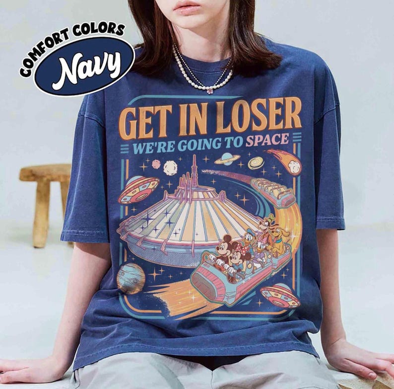 May include: Navy blue t-shirt with the text "GET IN LOSER WE'RE GOING TO SPACE" and a graphic of a space-themed amusement park ride with Mickey and friends. The shirt has a vintage, distressed look.