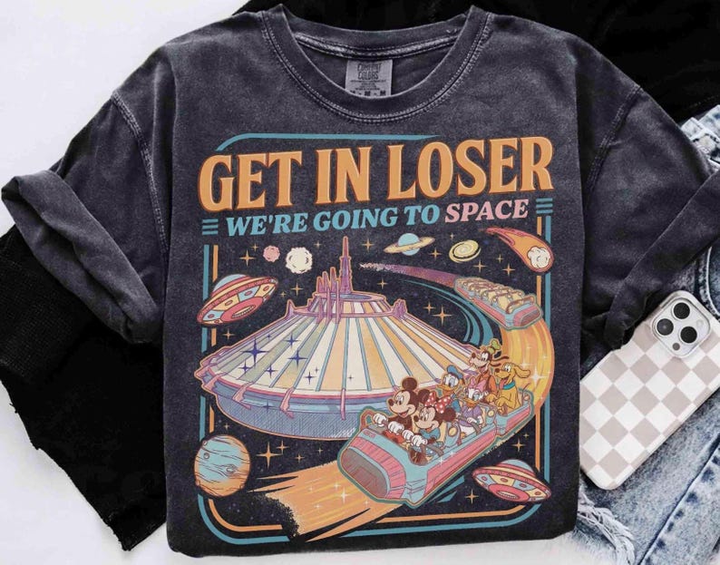 May include: Dark gray t-shirt with a retro graphic that reads "GET IN LOSER WE'RE GOING TO SPACE." The design features a space-themed amusement park ride with cartoon characters and flying saucers.